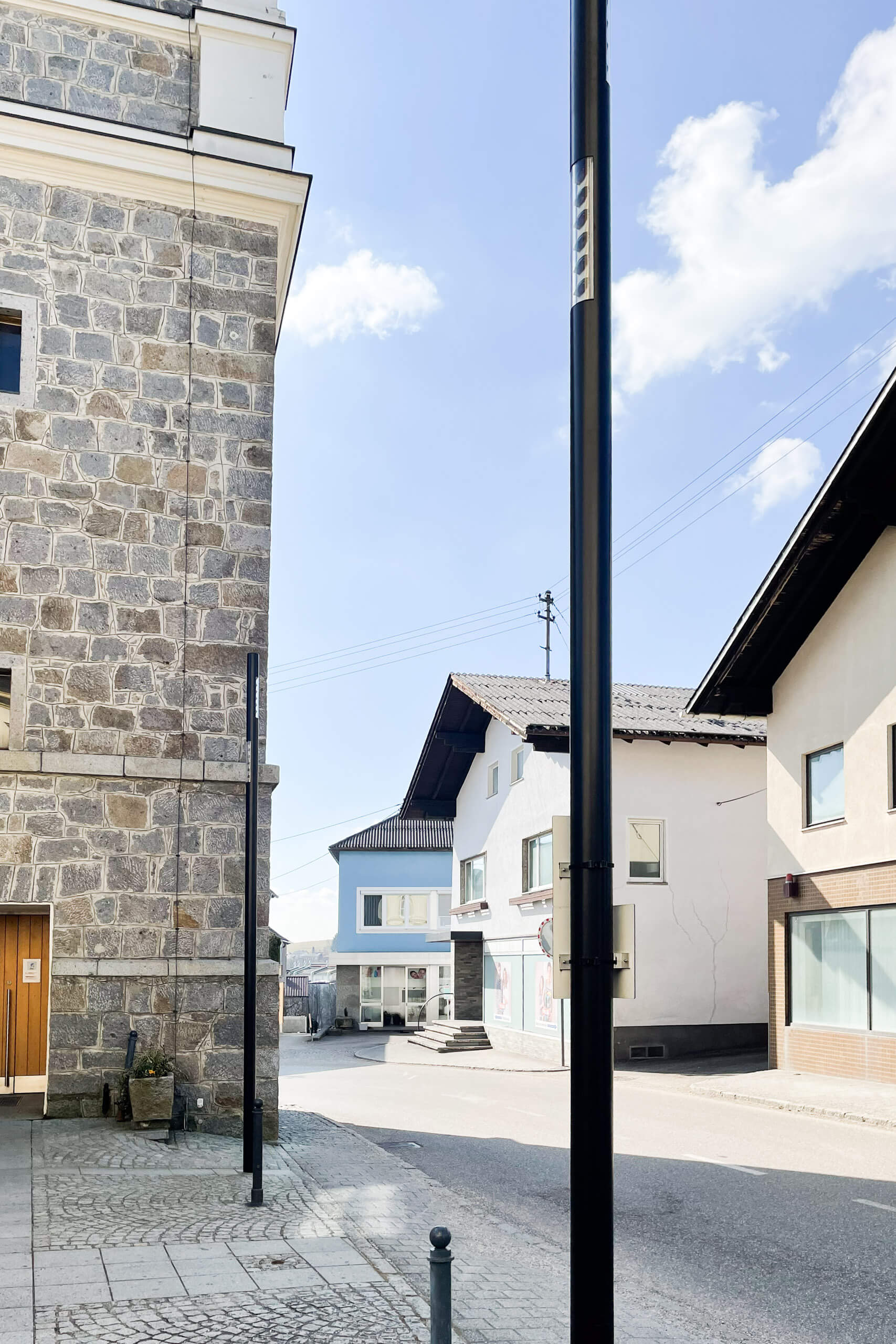 Straßenansicht mit Steinfassade und modernen Gebäuden im Tageslicht
