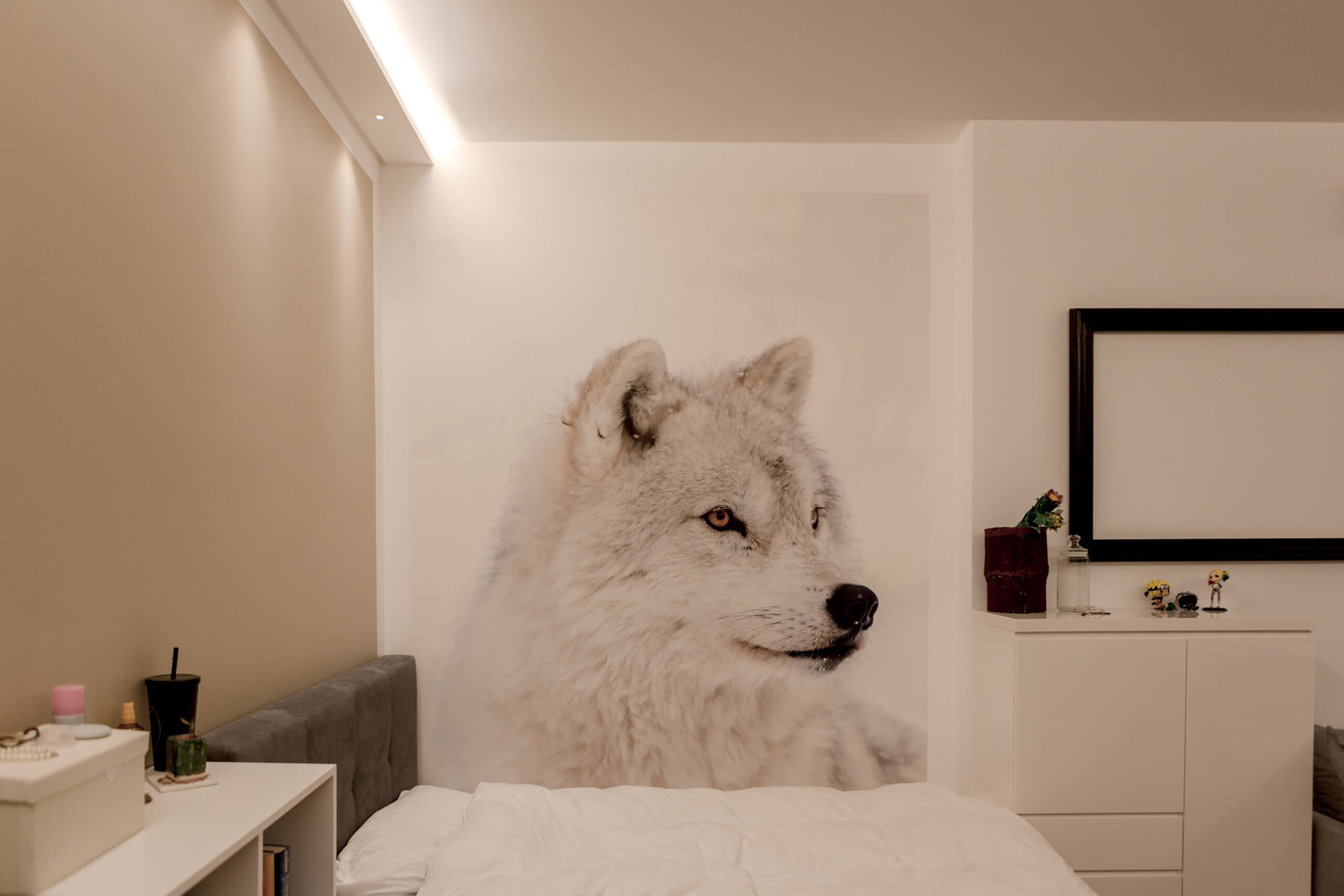Modernes Schlafzimmer mit großformatigem Polarwolf-Wandbild und dezenter Beleuchtung
