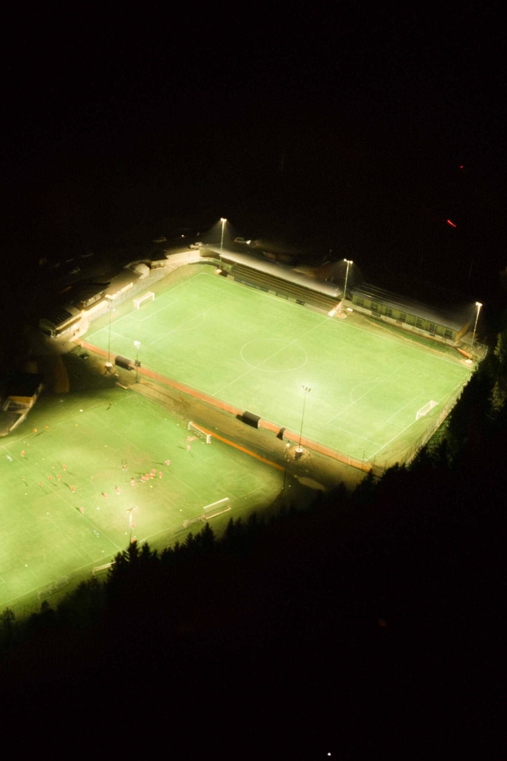 Beleuchtete Fußballplätze bei Nacht mit Flutlichtstrahlern von Illumina